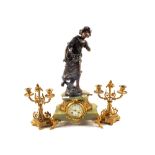 A French Onyx and gilt metal clock garniture with spelter flower maiden mount and a pair of gilt