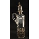 A cut glass Gin decanter with Silver holder with figure,