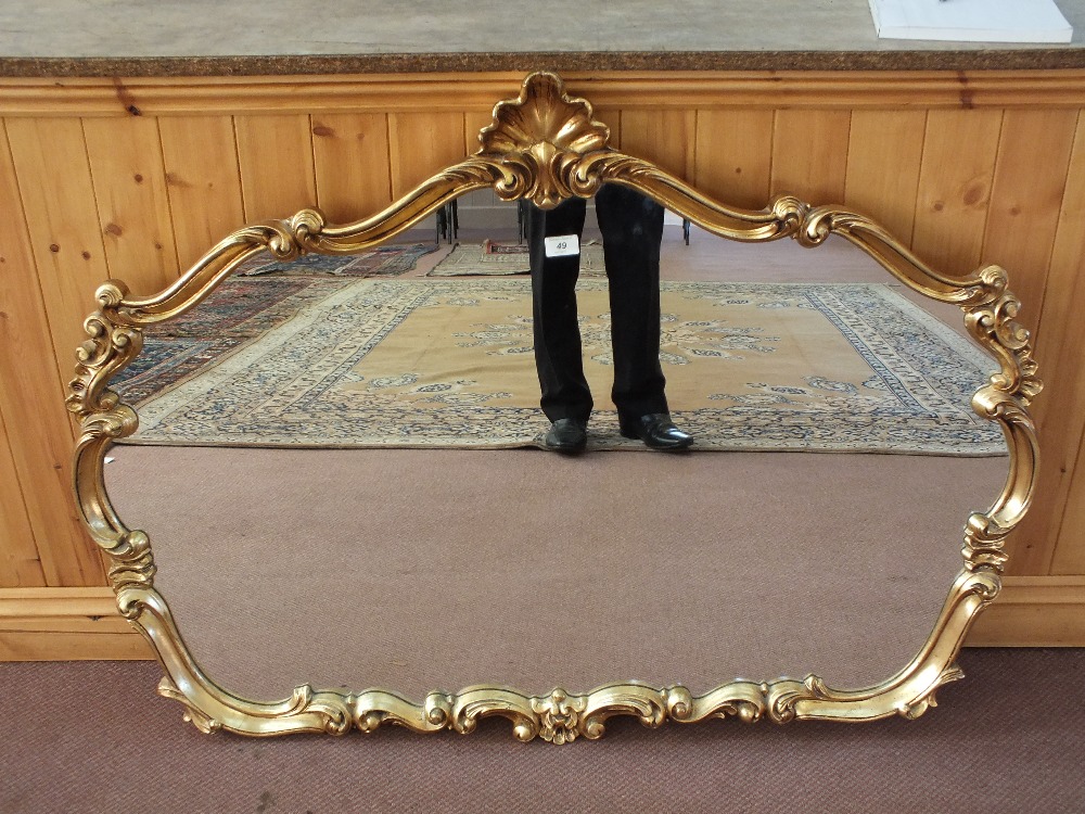 A shaped gilt wall mirror
