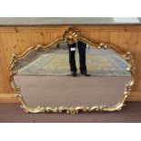 A shaped gilt wall mirror