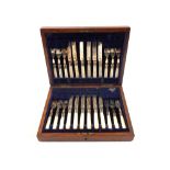 A Mahogany canteen of twenty four Silver plated and Mother of Pearl tea knives and forks