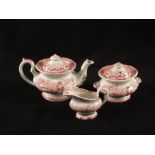 A three piece Victorian pottery red transfer childs tea set comprising of a teapot and cover,