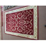 A Chinese maroon and cream floral rug,