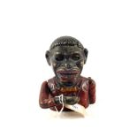 An iron ethnic boy mechanical money box