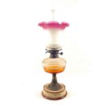 A cut glass oil lamp with pink etched shade on Royal Doulton style stoneware base