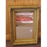 A rectangular mirror in heavy gilt frame by J.