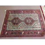 A Shiraz red ground rug,