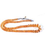 A cut Amber glass bead necklace with Silver clasp