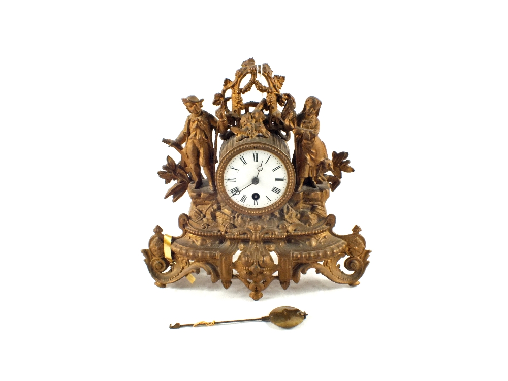 A gilt spelter figure mounted mantel clock