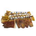 A pair of Canadian First Settler yellow suede and beadwork chaps, moccasins etc and a leather cover,