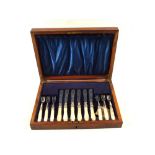 A Mahogany canteen of twelve Silver plated and Mother of Pearl fish knives and forks