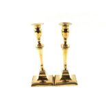 A pair of late 18th Century Adam style seamed Brass candlesticks with square bases,