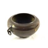 A Chinese Bronze circular pot with gold splash decoration and ring handles, mark to base,