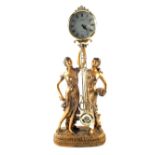 A gilt pendulum clock supported by two ladies