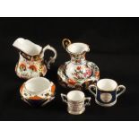 Miniature Royal Crown Derby loving cup, a miniature Royal Doulton cup and saucer, a Derby small pot,