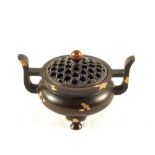 A Chinese Bronze two handled Koro with gold splash decoration and mark to base,
