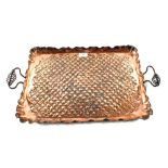 An Arts and Crafts hammered Copper tray with twin wrought iron handles,