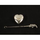 A Silver Mr Punch button hook,