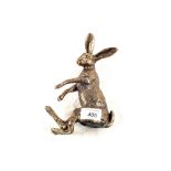 A bronzed figure of a shelf sitting Hare,