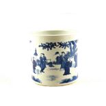 A Chinese porcelain cylindrical brush pot decorated with figures in a landscape in underglaze blue