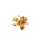 An 18ct Gold flower brooch set with two Sapphires