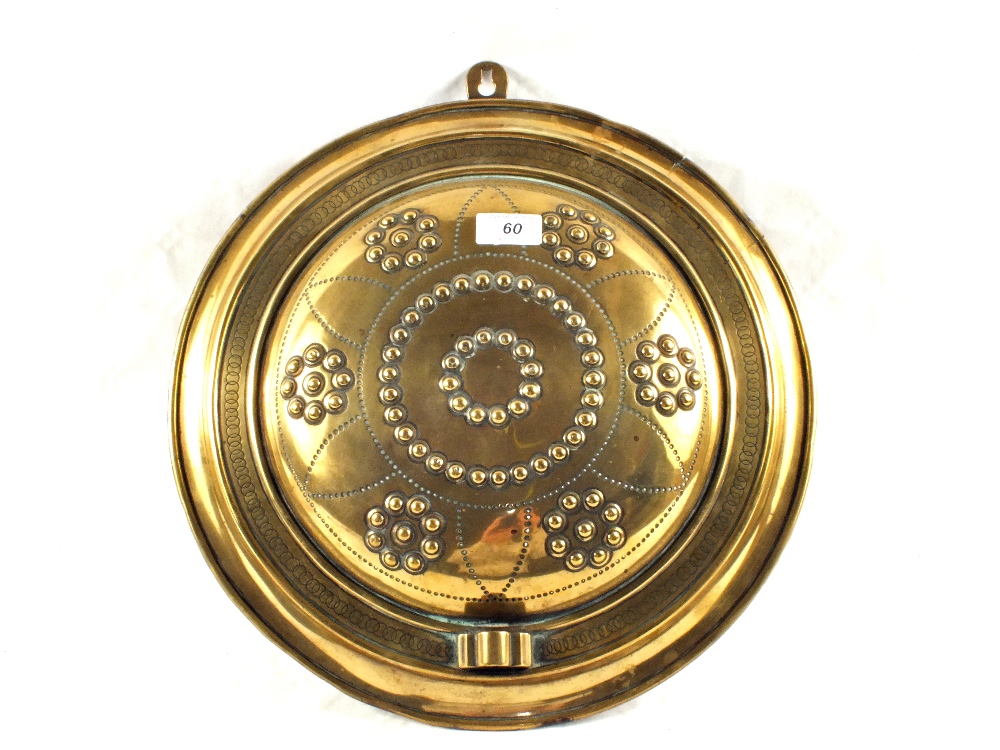 A 19th Century circular Brass wall sconce with embossed and punched decoration,