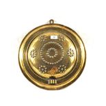 A 19th Century circular Brass wall sconce with embossed and punched decoration,