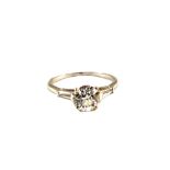 A large solitaire Diamond ring, the shoulders set with a baguette cut Diamond each side,