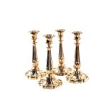 A set of four early Victorian Silver candlesticks with loaded shaped rounded bases and detachable