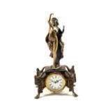 An Edwardian Brass mantel clock with standing lady mount