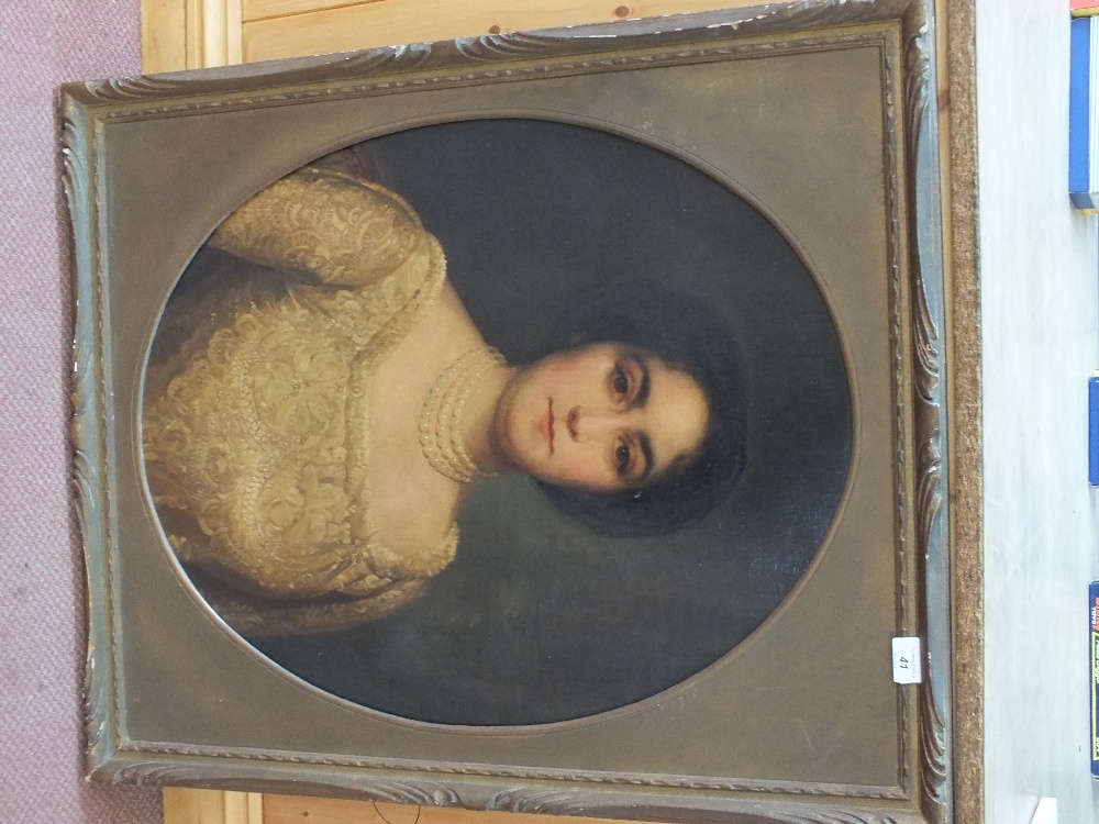 Unsigned oil on canvas laid to board, three quarter length oval portrait of a lady,