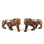 A pair of carved hardwood lions