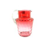 A Victorian cranberry glass water jug