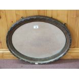 An oval wall mirror