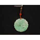 A circular carved Jade pendant