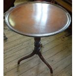 A 19th Century Mahogany circular snap top table on turned column and tripod legs