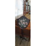 A Victorian Mahogany pole screen with shield shaped tapestry panel