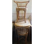 A cane breakfast bar and two matching chairs