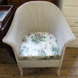 A pair of white painted narrow chest of eight drawers and a Lloyd Loom commode chair