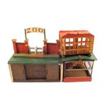 A wooden toy zoo including cages and lead animals