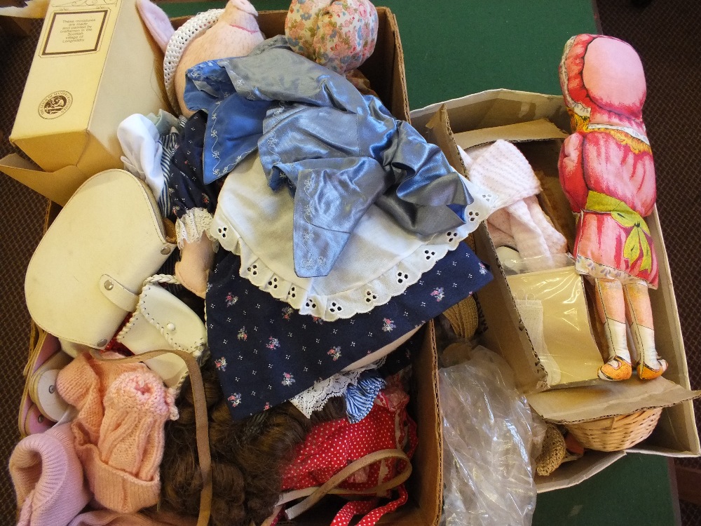 Two boxes of soft dolls, clothing,