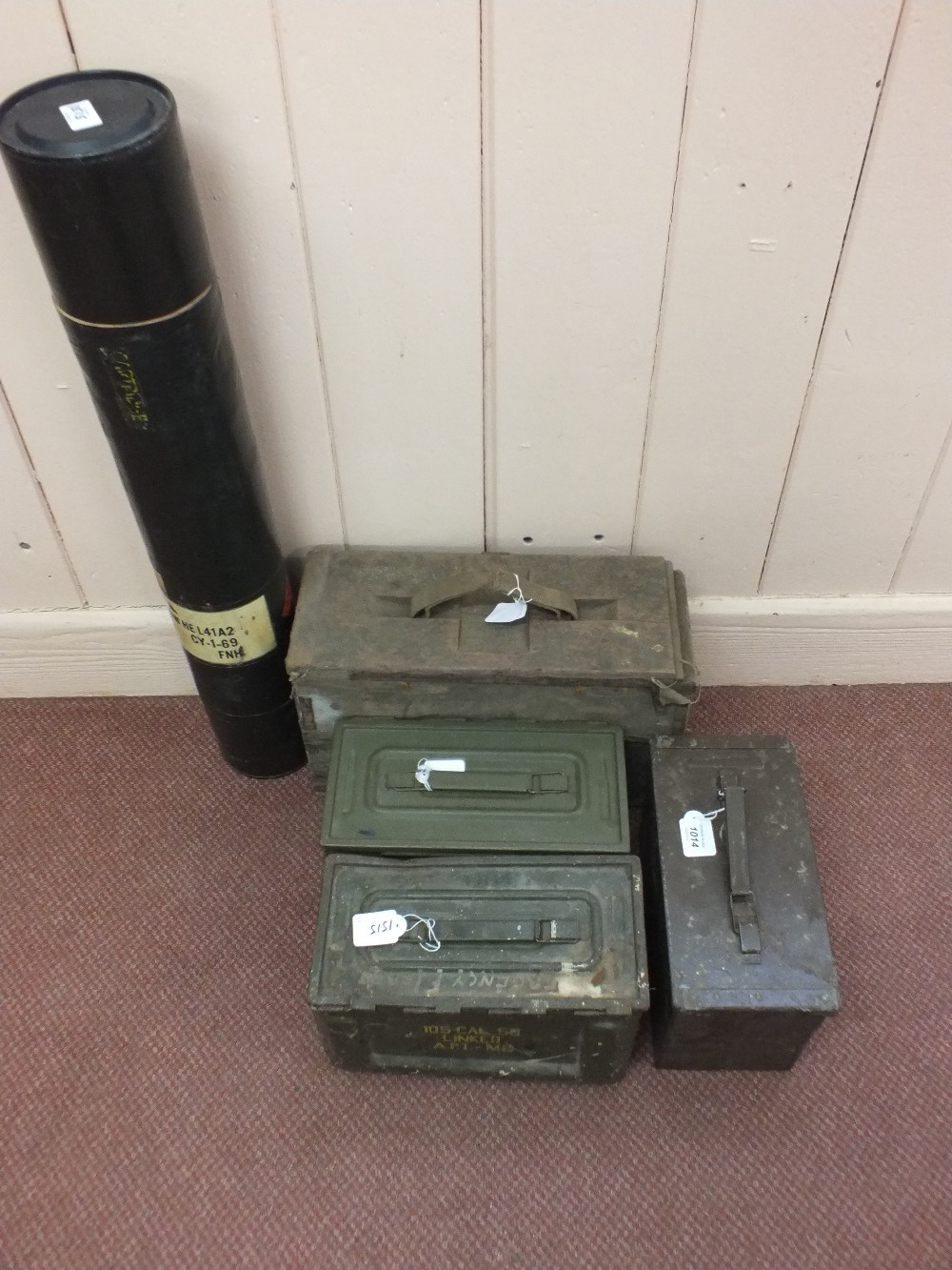 Three metal small arms ammunition boxes with a wooden 20mm example and a 105mm shell tube