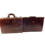 A leather writing case and one other