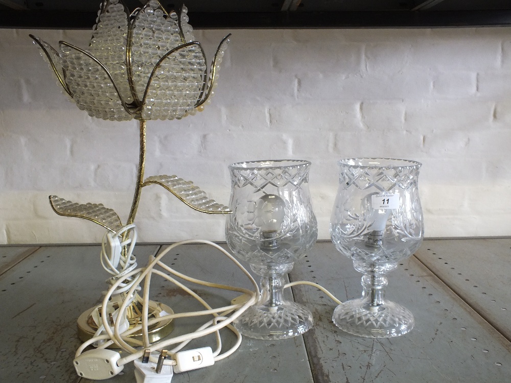 A pair of cut glass table lamps and one other