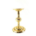 A Scandinavian Arts and Crafts Brass candle stand with repousse decoration and wide circular base,