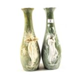 A pair of continental agate glazed vases with relief lady decoration (one cracked)