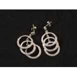 A pair of 18ct White Gold drop earrings in the form of three overlapping hoops,