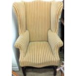 A 19th Century wingback armchair on fluted legs