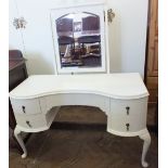 A modern white kidney shaped dressing table