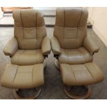 A pair of light brown Stressless leather recliners with matching footstools